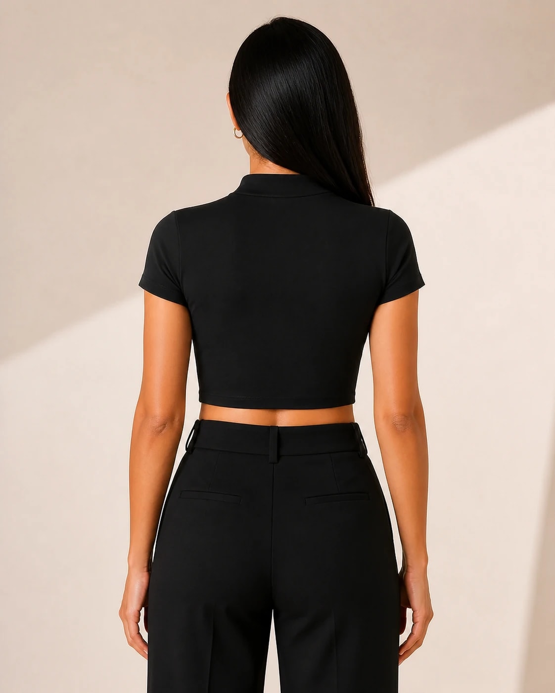 Top crop cuello alto en negro, vista de espalda en modelo