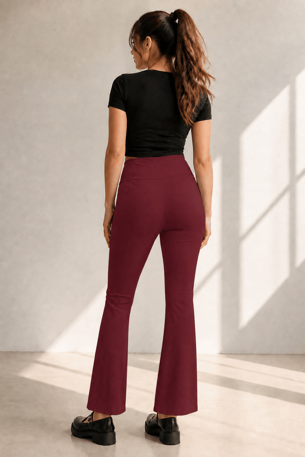 Pantalon acampanado cintura alta en vino, vista de espalda en modelo